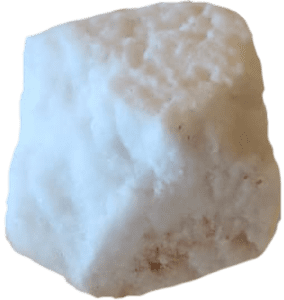 A large white rock with some brown spots on it